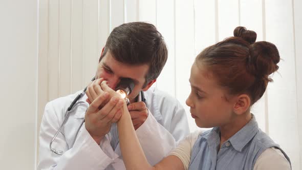 A Nice Little Girl Is Sitting Quietly While the Doctor Examines Her