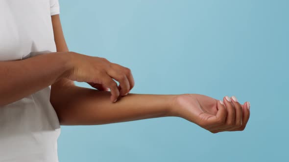 Unrecognizable African Woman Scratching Itchy Arm Over Blue Background Cropped