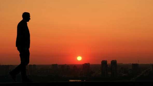 Businessman Looking at the Town at the Dawn