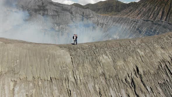 Hikers take selfie on cellphone on Bromo volcano