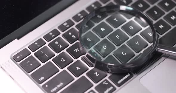 Magnifying Glass Lies on Computer Keyboard Slow Motion  Movie