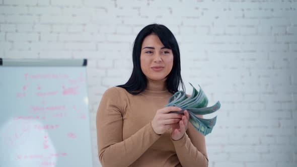 Portrait of smiling woman with dollar banknotes. 