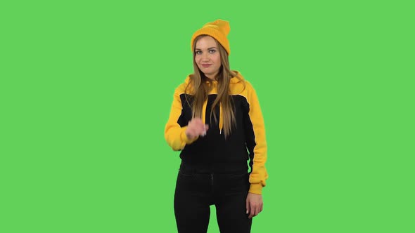 Modern Girl in Yellow Hat Is Making Sign Ok. Green Screen