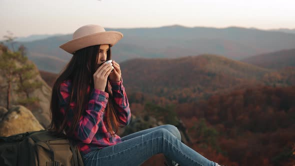 A Young Woman is Drinking Hot Tea