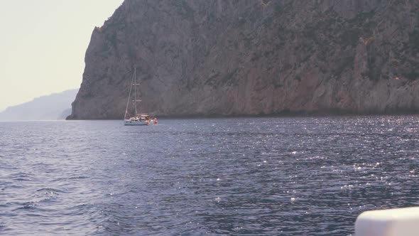 View of Yacht Near Rocky Island of Mallorca or Ibiza
