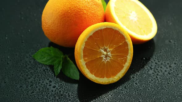 Orange with Leaf on Wet Table