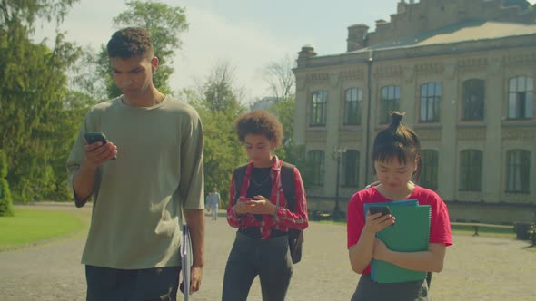 Portrait of Diverse Multiracial College Friends Networking Online on Phones