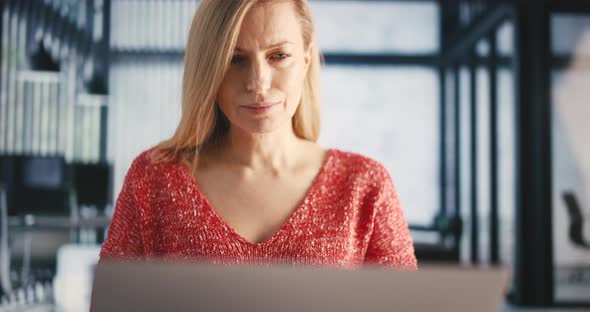 Woman Using Laptop at Office