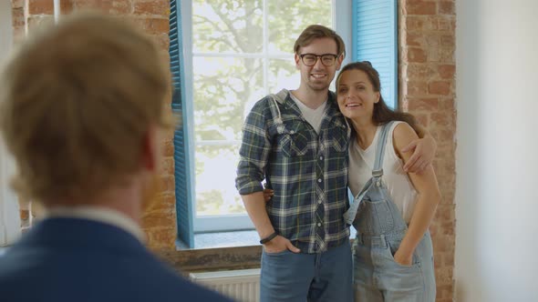 Young Happy Couple Meeting Architect for House Redecoration