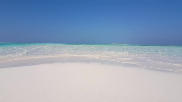 Tropical flying clean view of a white sandy paradise beach and aqua blue water background in high re