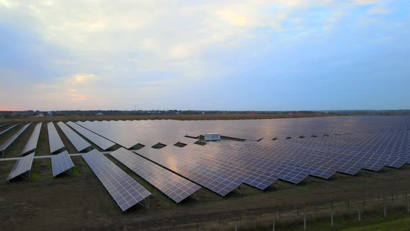 Aerial Drone View Into Large Solar Panels at a Solar Farm at Summer Sunset. Solar Cell Power Plants