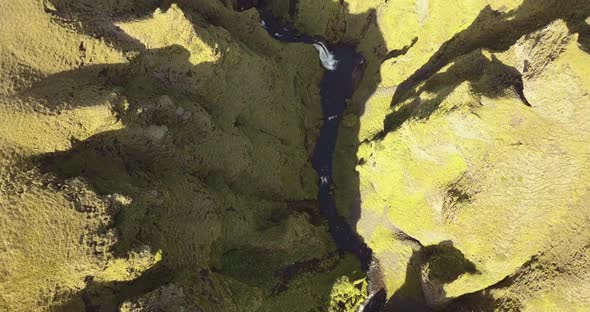 an aerial shot of a gorge from above in iceland