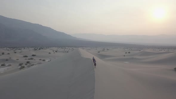 Aerial Drone Shot of Group of People Walking on Sand Dune in Death Valley