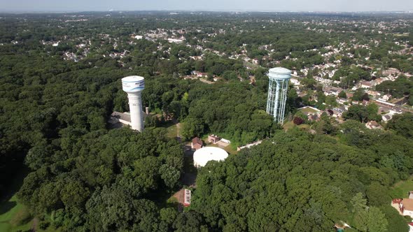 A high angle view over water towers in a suburban neighborhood on Long Island, NY on a sunny day. Th