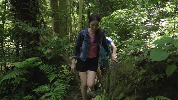 Asian Couple Hiking In The Forest