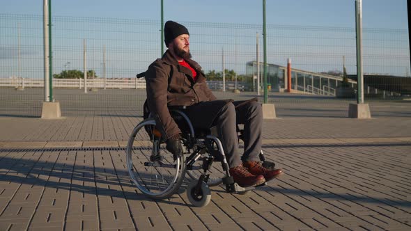 Lonely Outing of a Handicapped Man in Wheelchair