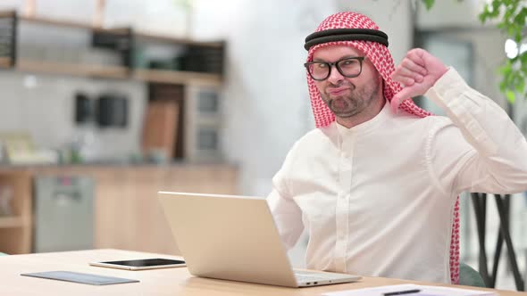 Thumbs Down By Disappointed Young Arab Businessman Working in Office 