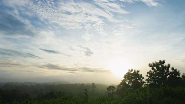 Fluffy fog cloud flowing on natural forest mountain from time lapse sunrise cloudy sky on morning