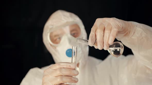 Lab Worker Pouring Liquid Into Measure Tube