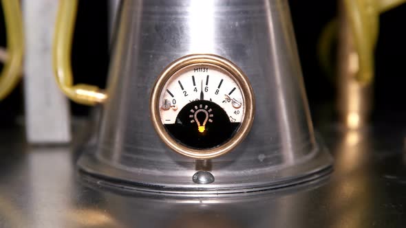 Round, Vintage Gauge Voltmeter, on Which the Arrow Showing Voltage Is Randomly Jumping on a Metal