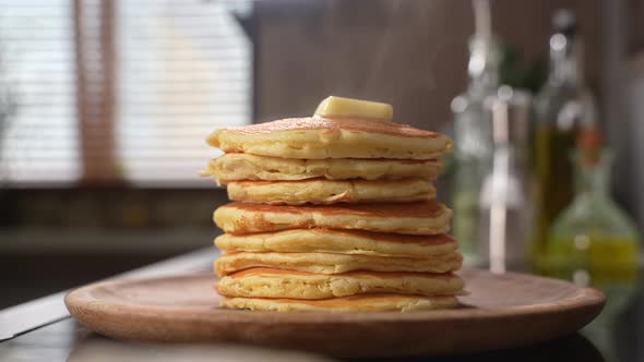 A Piece of Butter Melts on a Stack of Hot Pancakes