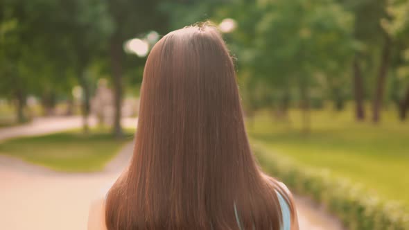 Back View Close Up Woman Walking on the Street in City Park Summer Outdoors