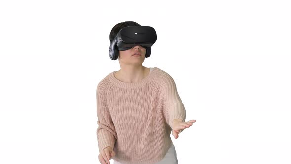 Cute Young Woman Walking and Using Interactive VR Headset on White Background.