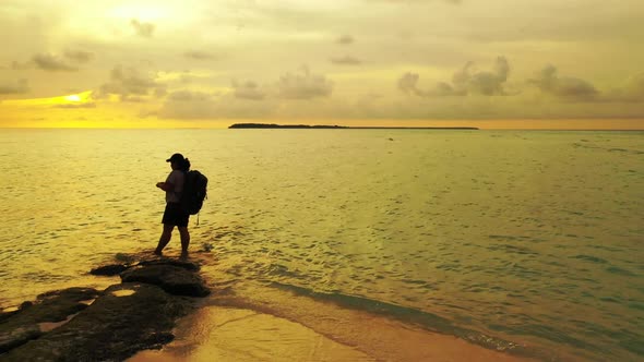 Single female happy and smiling on paradise island beach vacation by blue sea with white sandy backg