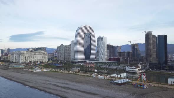 Aerial view of modern building of Marriott Hotel and water channel,Batumi,Georgia. Unfinished skyscr