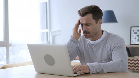 Pensive Adult Man Reading Book at Work