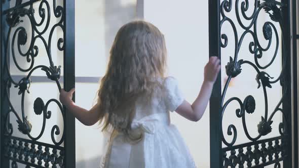 Pretty Girl in Holiday Dress Closes Forged Lattice at Home