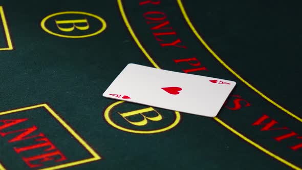 Croupier Deal Cards, Shows Two on Green Table at Casino