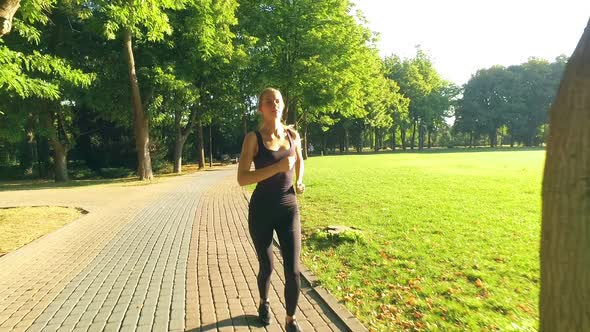 Runner Woman Running In Park Exercising Outdoors