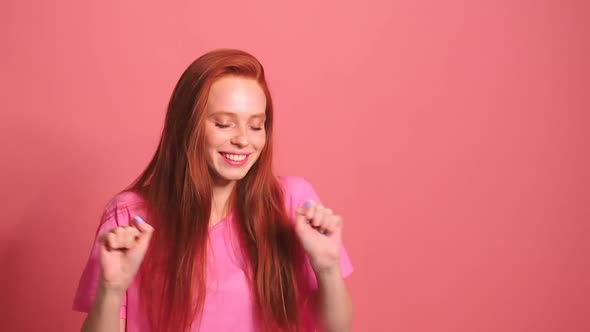 Redhaired Ginger Woman in Pink Studio Background Smile and Feeling Good