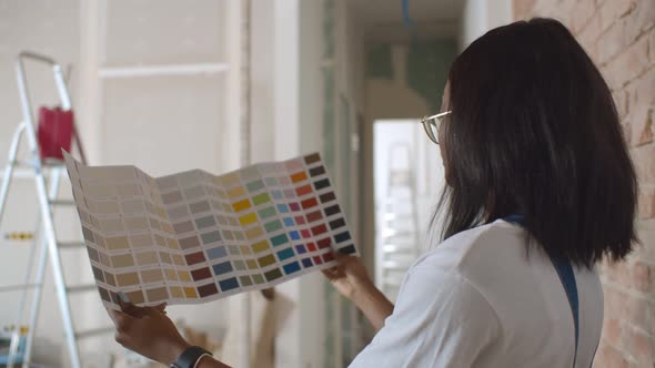 Attractive Young African Woman Choosing New Colors for Home Renovation