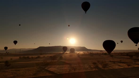 Silhouettes of Flying Hot Air Balloons Over Cappadocia Lands in Turkey on Sunset