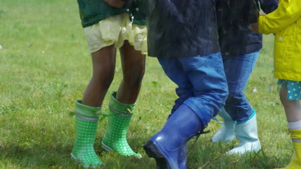 Children Running in Circle in Rain