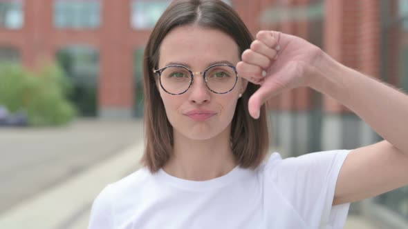 Thumbs Down by Young Woman, Outdoor