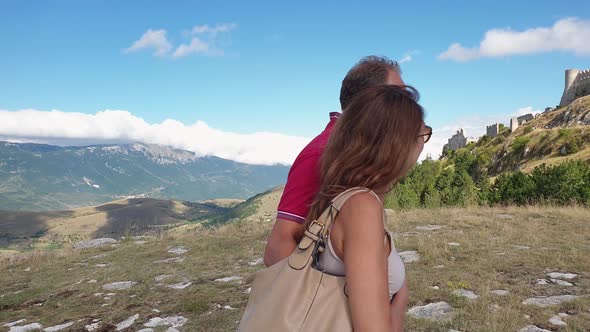 Romantic couple visits Rocca Calascio Abruzzo fortress, near L'Aquila. Italy