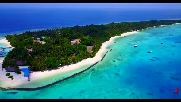 Aerial flying over landscape of exotic coastline beach lifestyle by blue ocean with white sandy back