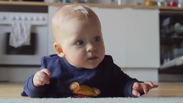 Baby Girl Making Efforts To Crawl on the Floor at Home