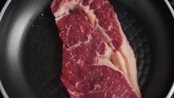 Cooking Rib Eye Steak with Herbs on Grill Pan Close Up Macro Pan Fresh