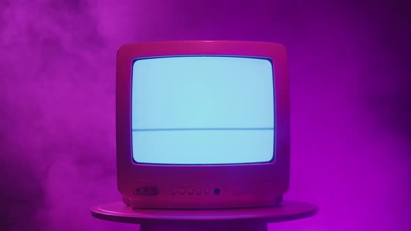 Old Vintage Television on Pink Neon Background Closeup