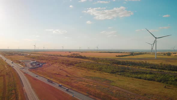 Windmills for Electric Power Production in the Meadow. Group of Windmills for Renewable Electric