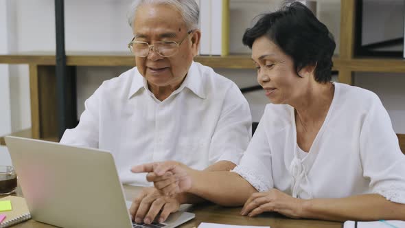 Family concept. Old couple working on home computers. 4k Resolution.