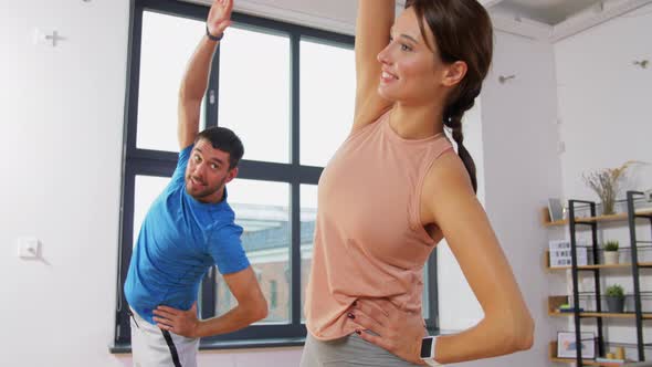 Happy Couple Exercising at Home