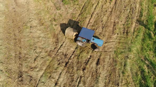 Tractor Carrying Bales Of Hay