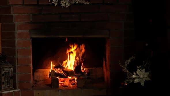 hot fire burns in the brick home fireplace. cozy Weekend. Warm in the house.