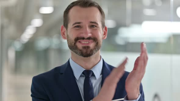 Portrait of Excited Businessman Clapping 