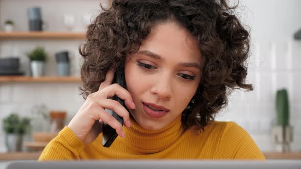 Close Up Hispanic Curly Woman Student Talking on Mobile Phone Using Laptop